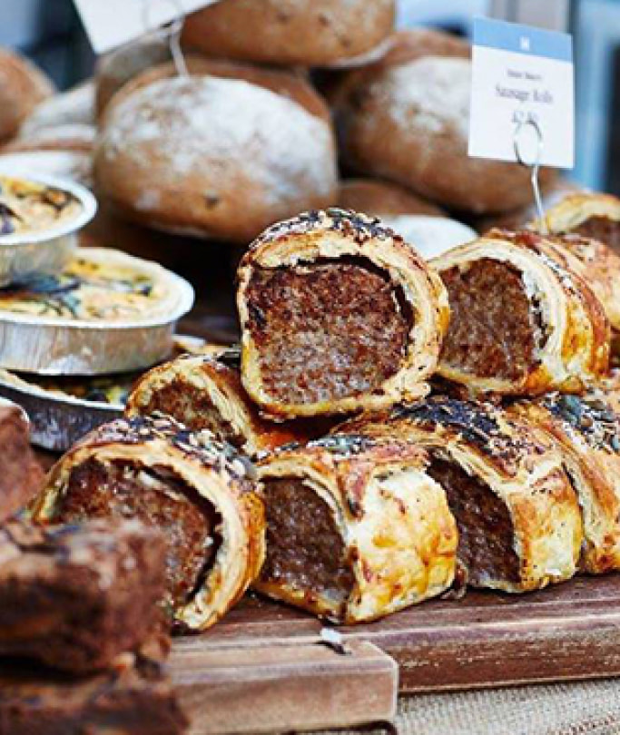bakery display with sausage rolls and bread rolls